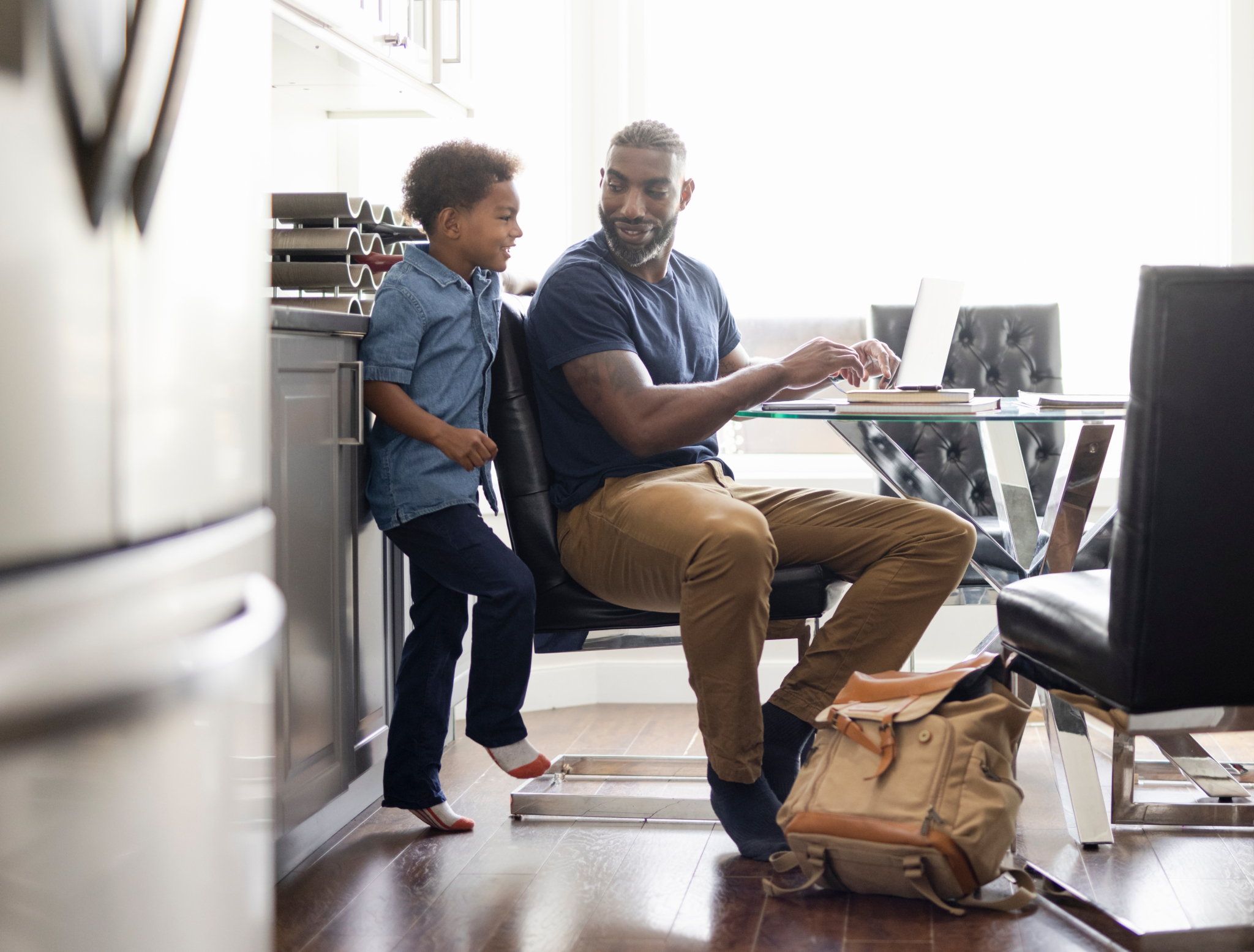 Son watching father work from home at dining table | Treadwell Therapeutics